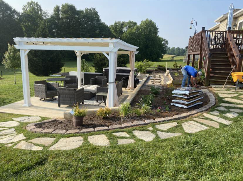 White pergola and patio seating area under construction