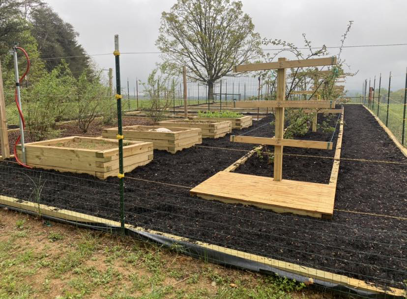 Newly installed raised garden beds with drip irrigation on an East Tennessee property