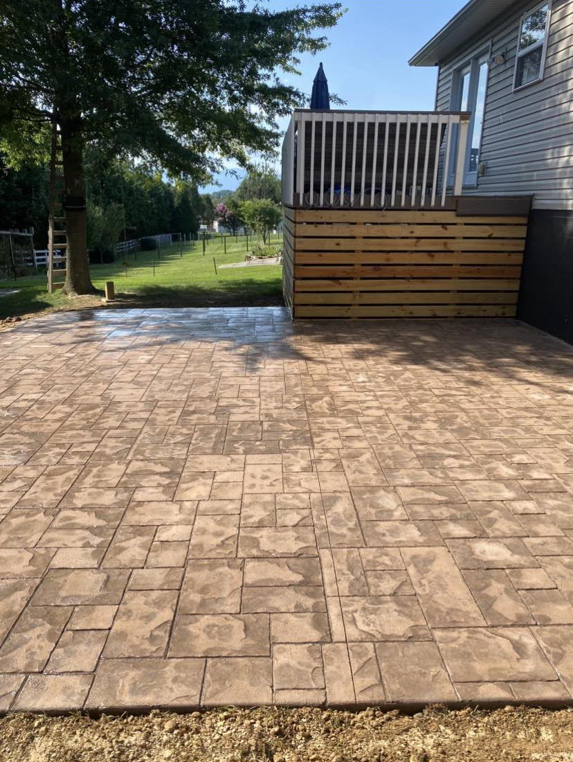 Large stamped concrete patio installed by Complete Property Management