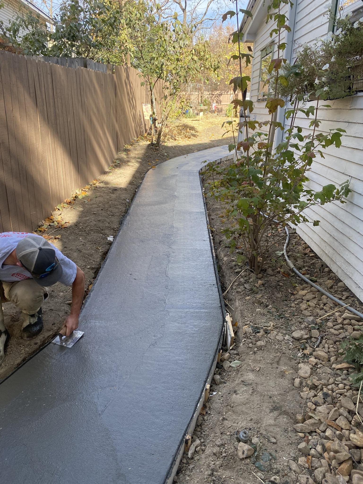 Complete Property Management crew finishing a freshly poured concrete walkway