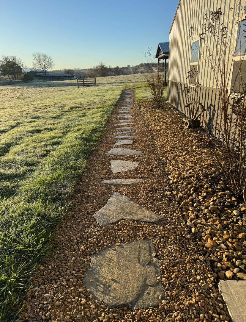 Gravel drainage bed and stepping path along the side of a building